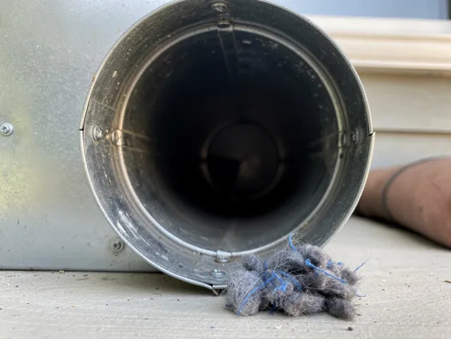 East Windsor Dryer Vent Cleaning technician using specialized equipment to clear severe dryer vent blockage in East Windsor